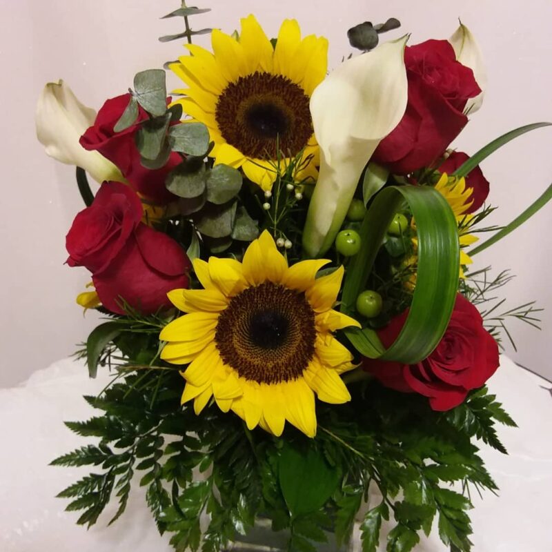 This beautiful small sunflower mixed arrangement its great for all occasions such as birthdays, getwell, Thinking of You or Just Because. features sunflowers, red roses and white calla lilies nestled in greens and solidago and eucalyptus and green hypericum berries. Delivery fee inluded in price.We deliver to Miami-Dade and broward counties.